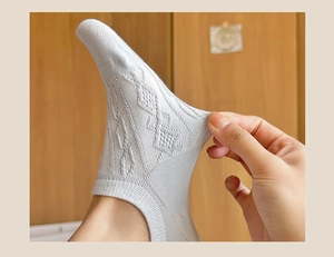 Detail showing the superior elasticity and texture of strawberry bow low cut socks