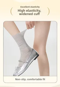 Detailed view of high-elasticity wide cuffs on grey lace mesh socks for women