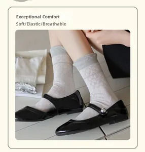 Detail of grey crew socks with argyle texture paired with black Mary Jane shoes