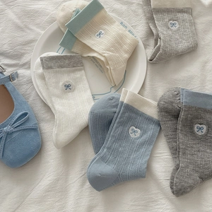 Five pairs of ribbed cotton crew socks with heart embroidery and bows in soft colors