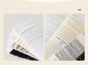 Detail of sheer lace mesh socks showing delicate floral patterns in white and black