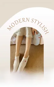 Detail of thin cotton liner socks featuring strawberry embroidery and elastic cuffs