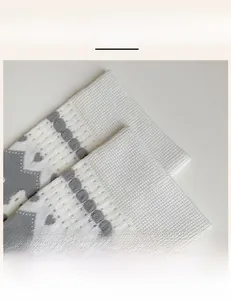 Close-up of high-elasticity ribbed cuffs on summer socks with gray geometric heart pattern