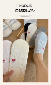 Detailed close-up of low-cut cotton socks featuring cute strawberry embroidery and knit texture
