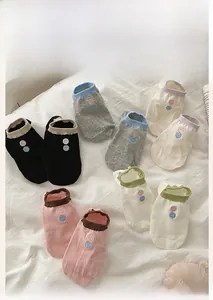 Detail of colorful cotton low-cut ankle socks with contrast rib cuffs and dot embroidery