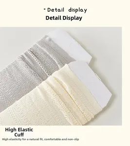 Detailed macro view of the elastic cuffs and dot pattern on hollow-out lace socks