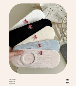Detailed view of women's low cut socks with cable knit texture and strawberry embroidery