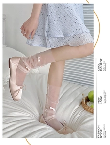 Detailed view of pink satin ballet flats with bow and sheer mesh socks with white bows