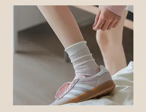 Detail of beige mesh crew socks with striped texture and seamless rolled cuff design