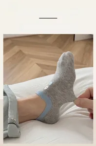 Close-up of light grey invisible sock showing high elasticity and blue contrast cuff