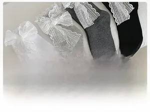 Close-up of sweet lolita style socks with delicate lace bow ties in four neutral colors