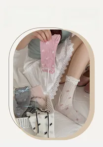 Detail of sweet floral crew socks with ribbon bow and elegant lettuce edge finish