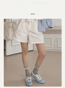 White lolita lace socks paired with light blue lace-up flats and casual shorts
