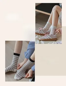Close-up of thin mesh and striped crew socks for women in stylish summer colors
