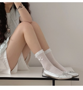 Detail of sweet pink striped socks with lace trim and silver ballet flats with bow accents