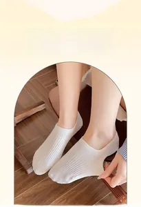 Detailed shot of white striped cotton invisible socks with non-slip and skin-friendly texture