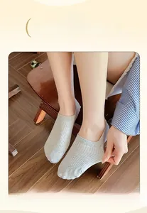 Detail of light grey low cut liner socks featuring a wide elastic band and ribbed cotton