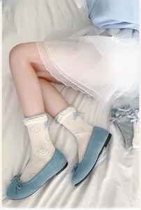 Detail of ballet style mesh socks with cute puppy print and light blue bow tie accents