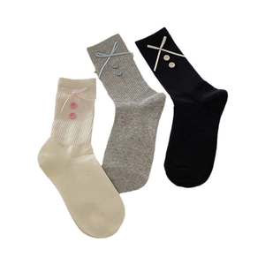 Three pairs of Japanese style mid-calf socks with bow tie and button accents