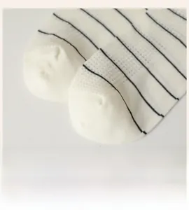 Close-up of smooth toe seams and breathable mesh texture on striped cotton socks