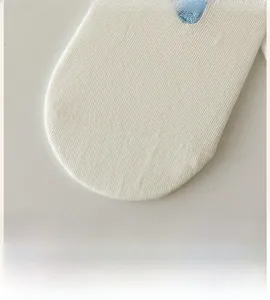 Detailed macro view of the smooth white knitted toe cap with fine ribbed texture and embroidery