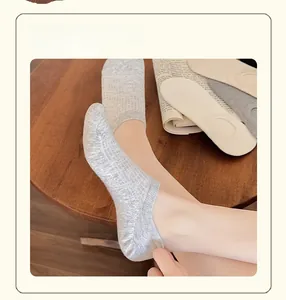 Detailed knit texture of breathable low-cut invisible socks in grey and beige tones