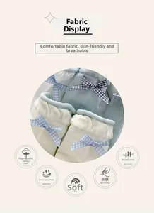 Detail of soft cotton kids socks with ruffles and blue checkered bow decoration