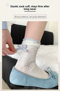 Detail of ballet style calf socks with cute puppy prints and lace bow cuffs in soft blue shoes