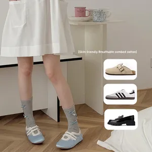 Breathable grey cotton socks with blue bows paired with minimalist ballet-style shoes