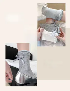 Close-up of ballet style socks with plaid bows and cartoon puppy jacquard patterns