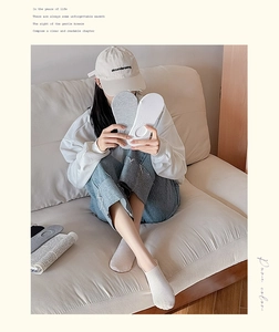 Detailed view of light grey and white low-cut invisible socks with ribbed knit texture