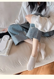 Detail of beige ribbed cotton invisible socks worn with casual denim for home comfort