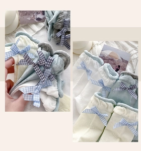 Close-up of ballet-style mesh socks featuring gingham bows and scalloped lace edges