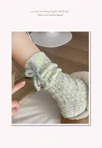 Detail of wool socks with bow showing thick knit texture and soft elastic cuff