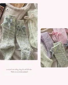 Detail of wool socks featuring cute 3D bows and colorful knit speckle yarn patterns