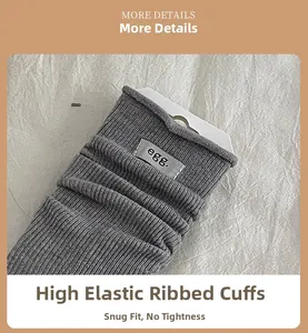 Detail of grey ribbed wool socks with high elastic cuff and stylish egg letter label