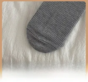 Detailed macro view of reinforced toe on dark grey ribbed knit wool socks for women