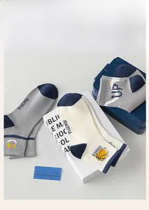 Close-up of cotton sports socks with basketball and smiley face embroidery details