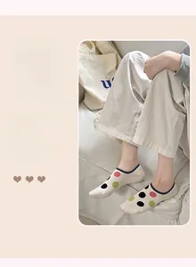 Detailed view of women's polka dot invisible boat socks with elastic navy blue trim