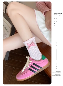 Detail of pink bow and ruffle trim on Japanese style cable knit mid-calf crew socks