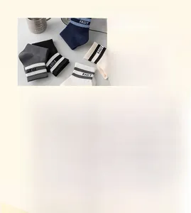 Detail of five pairs of combed cotton socks with FAST letter print and stripe cuffs