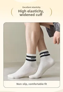 Detail of white cotton athletic socks featuring black stripes and FAST lettering detail