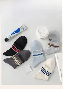 Flat lay of five pairs of cotton blend striped crew socks in neutral and pastel tones