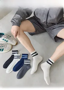 Detail of men's athletic socks featuring striped rib cuffs and FAST letter printing