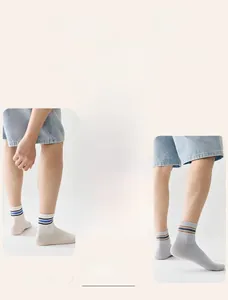 Detail of striped cotton sport socks featuring double needle weaving and breathable texture