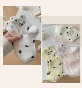 Détail de chaussettes en coton chat avec revers en forme d'oreilles et broderie