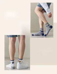 Detailed close-up of crew socks featuring knitted smile pattern and letter graphics