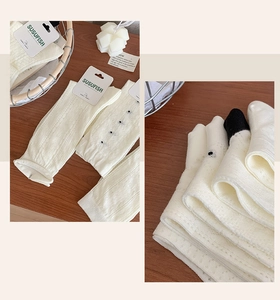 Detail of white mesh crew socks with breathable knit patterns and vertical textures