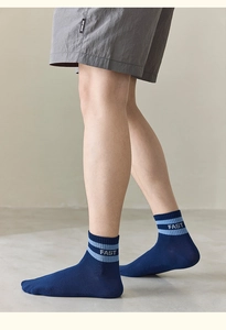 Detail of navy blue cotton sports socks with light blue stripes and FAST lettering