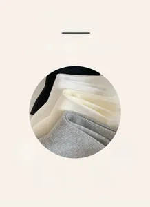 Detailed texture of vertical ribbed knit cotton socks in white, black, and beige colors